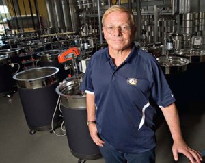 Man Standing next to chemistry equipment