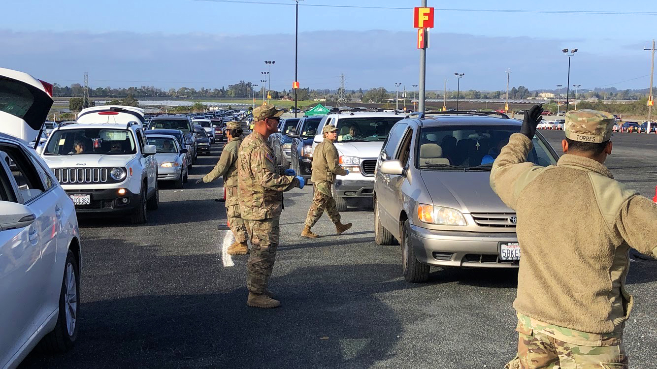 National Guard members helping out at drive-through food distributions. On this day, almost 3,000 families picked up a bag of food. (Photo Courtesy: Michelle Lee)