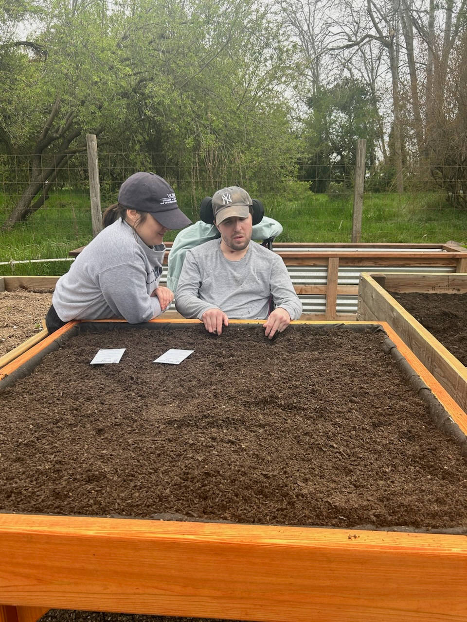 Mackensie Priley, director of development with CA&ES, and her brother Jacob Priley, who uses a wheelchair, helped make suggestions about navigating around the accessibility garden. Photo by: Priley family