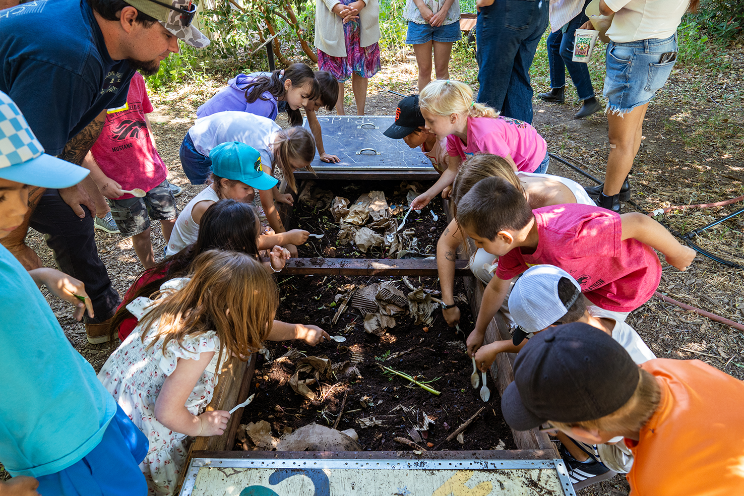 UC Davis students shared a lesson on composting while kids looked for worms in the compost bin. Photo by: Jael Mackendorf, UC Davis