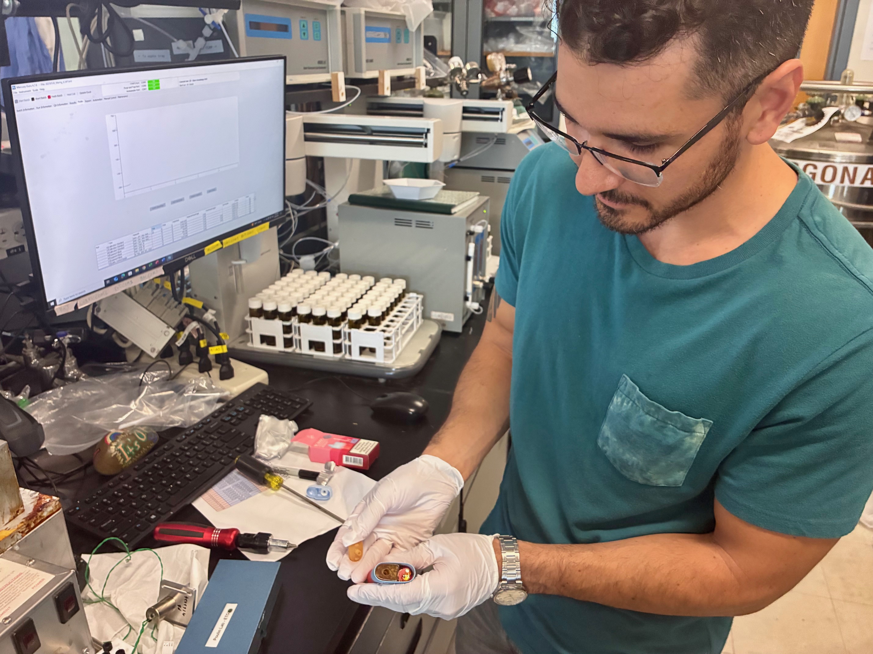 Mark Salazer in the lab with a disposable vape pod. (Kat Kerlin / UC Davis)