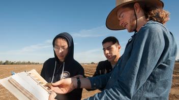 Students compare the color of a soil sample to the Munsell Soil Color Chart, which helps scientists assess the makeup of soil. (Gregory Urquiaga/UC Davis)
