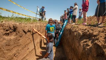 This class is stepping outside the classroom to learn about soil striations in the field.