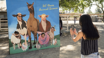 A group having their photo taken at the Cole Facility during Picnic Day on April 15, 2023.