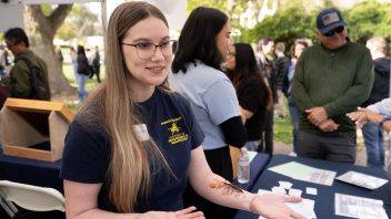 A student talks about animal biology with visiting prospective students and their families during the Aggie Day event. (Stephanie Perla/UC Davis)