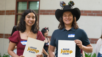 Two students smile with their awards at the 2025 End of Year Banquet by Aggie Jumpstart.