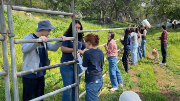 Students work together to build fences at the RIDE Foundation.