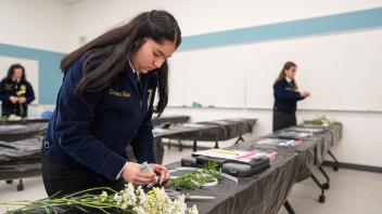 FFA students examine flowers at the Field Day competition.