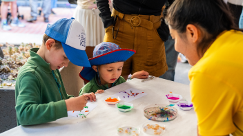 Children create beautiful art with the help of some colorful maggots at this 2025 Picnic Day event. (Jael Mackendorf/UC Davis)