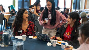 An advisor talks with a group of students during the UAP Slice of Advising event.