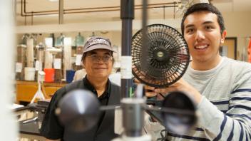 Professor Kyah Tha Paw U talks with David Quinones, an atmospheric science major, as he tests the wind directional during a Atmospheric Science class.