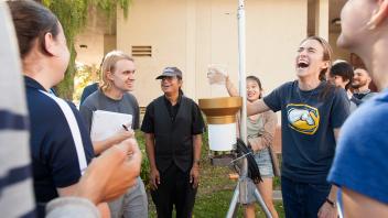 Professor Kyah Tha Paw U and teaching assistant Janae Clay laugh with the students as they instruct them on reading a rain catcher during a Atmospheric Science class.