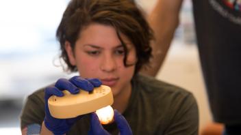 Nadya Dooley, a masters student in avian science, does candling of the ducks eggs during the wood duck research center work.