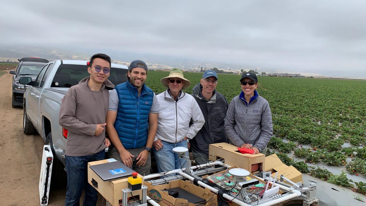Vougioukas with lab members and the strawberry harvest-aid FRAIL-bot. (Stavros Vougioukas/UC Davis)