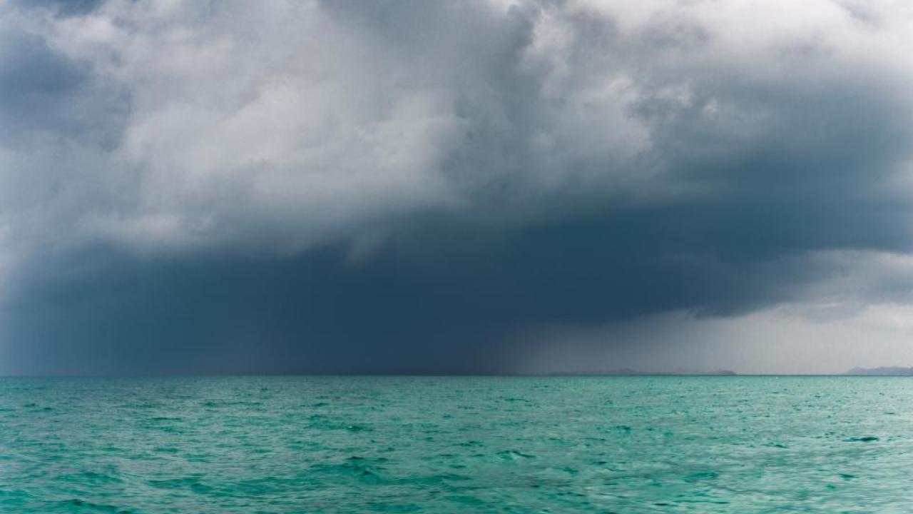A typhoon moves over the sea in Thailand. Without the lightness of water vapor, the impacts of climate change to the tropics would be far worse, a UC Davis study found. (Getty)
