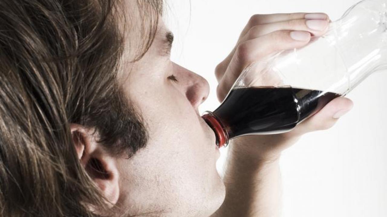 Person consuming beverage.