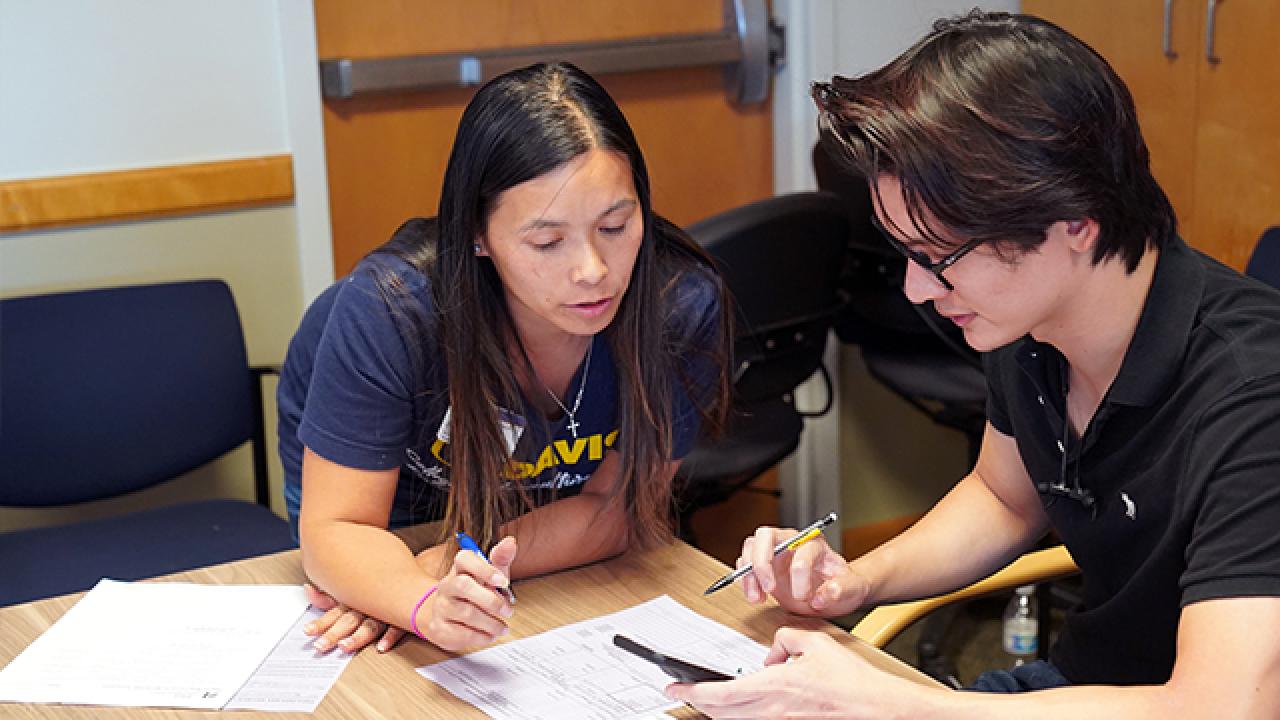 A CA&ES advisor with a student.