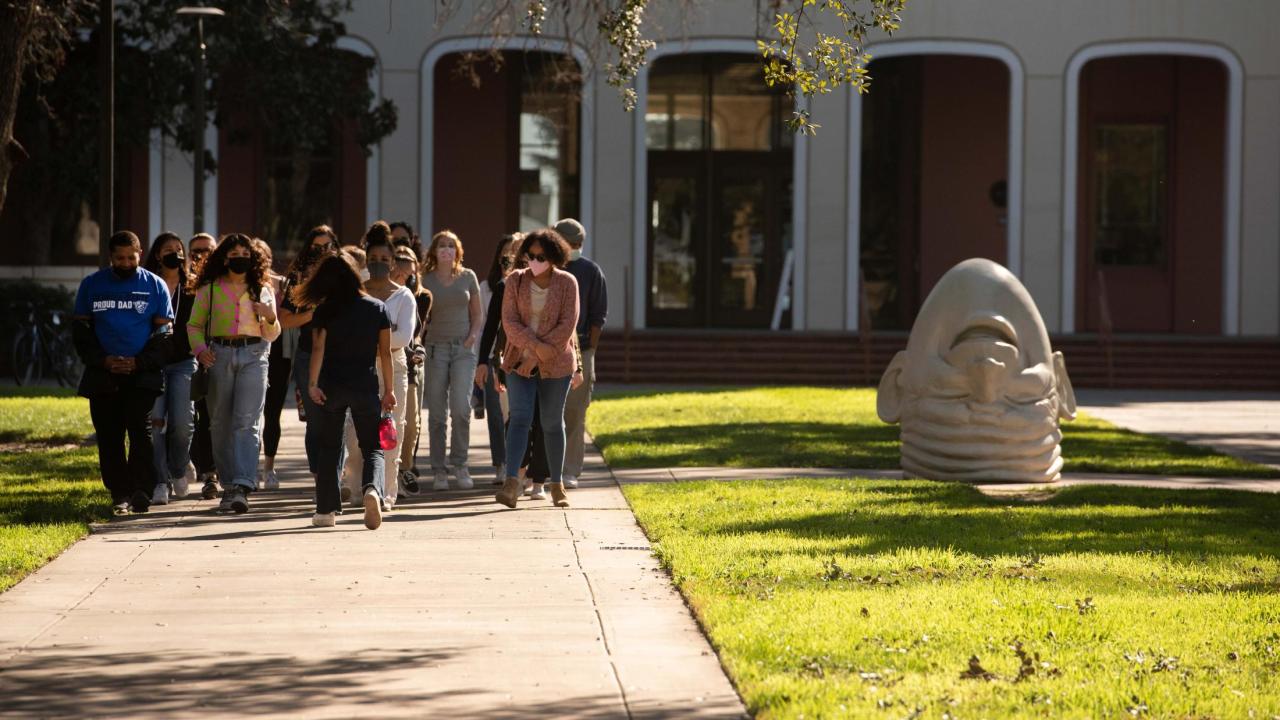 Prospective students and their parents take a walking tour of campus on February 7, 2022. The tour visits an Egghead outside Mrak Hall.
