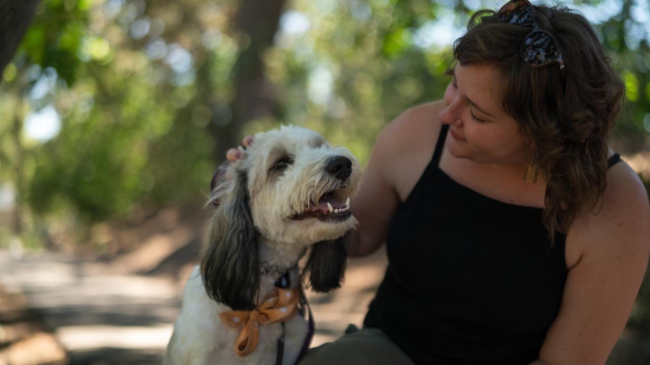 Amanda Frazier, who studies polar fish in Antarctica, gets some snuggles in with her dog, Maisie, at UC Davis in June 2022. (Alysha Beck/UC Davis)