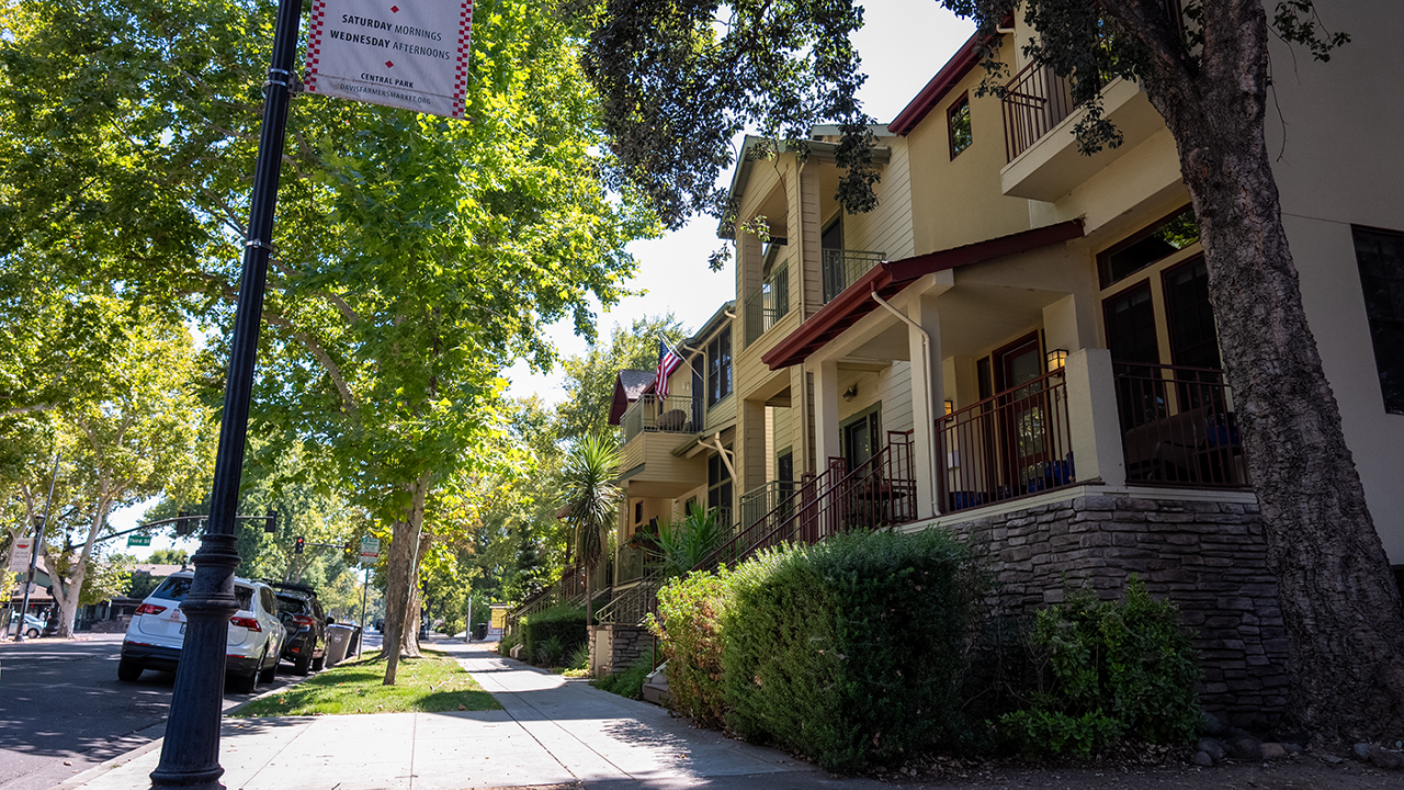 A street with houses with sidewalk.