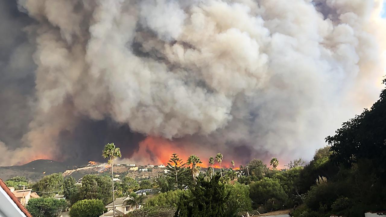 Wildfire smoke from the Woolsey Fire billows over the sky in Malibu, California in November 2018. Aerosols in smoke plumes hundreds of hours old can still affect climate change, a UC Davis study shows. (Getty)