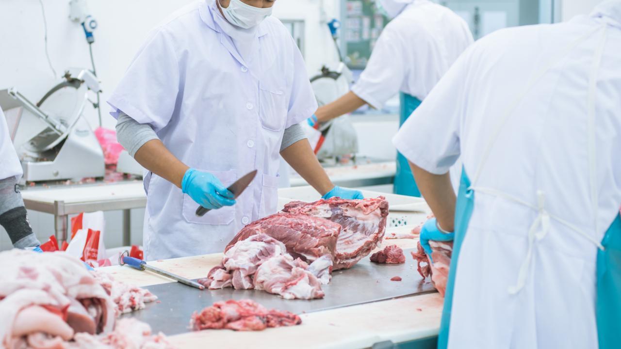 Butcher cutting meat.