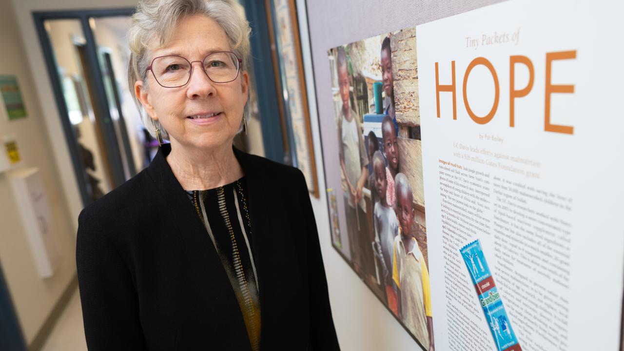 A person standing next to a poster or information board.