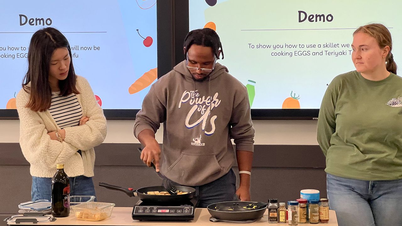 Makhi Jones (pictured center) gives cooking tutorial while participating in the Good Foods Garden internship.