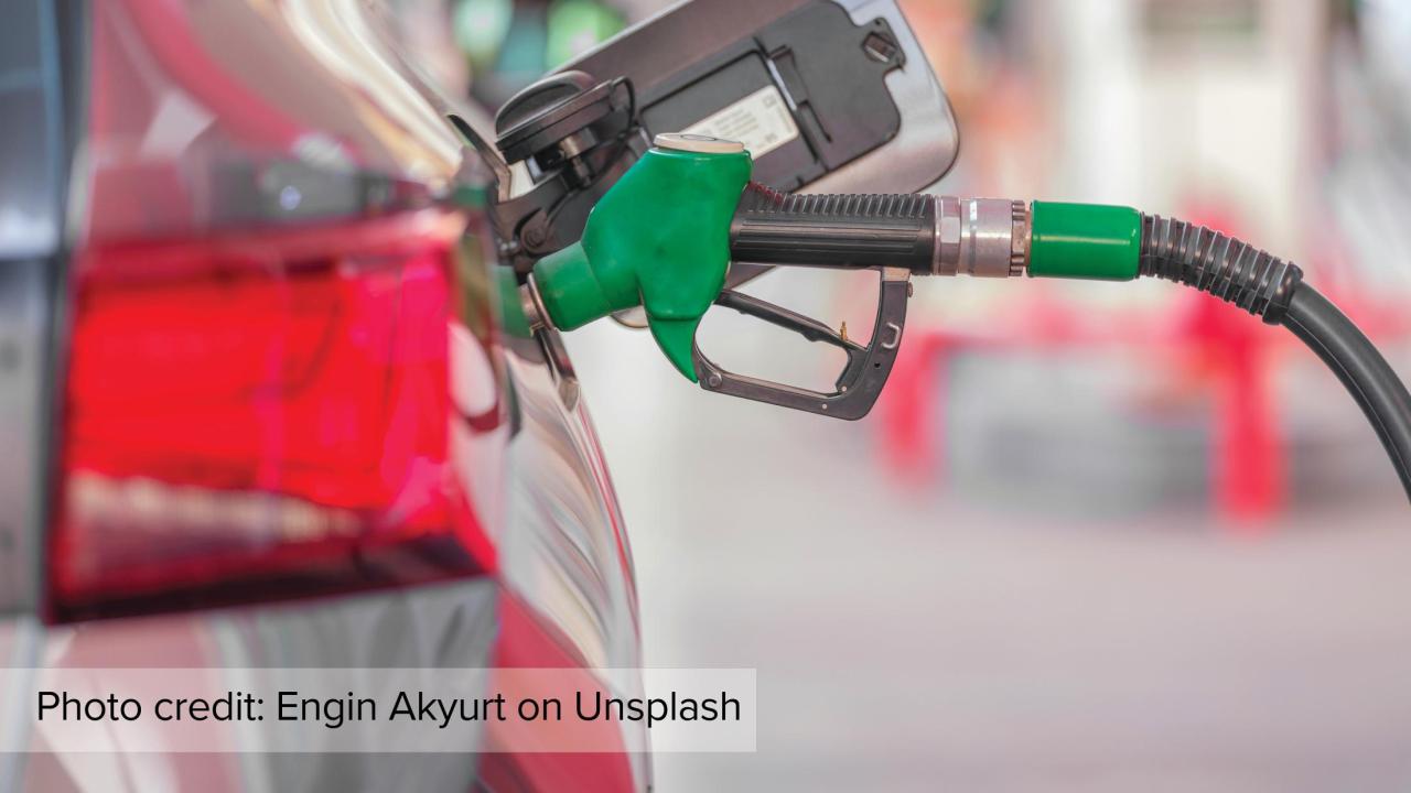 A car getting filled at the gas pump.