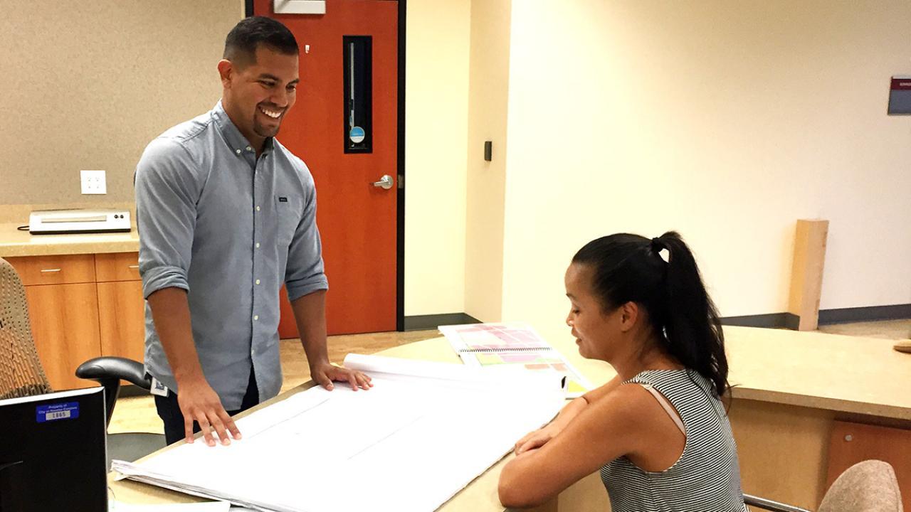 Nick Sosa talks with another person at his internship with the city of Rancho Cordova.