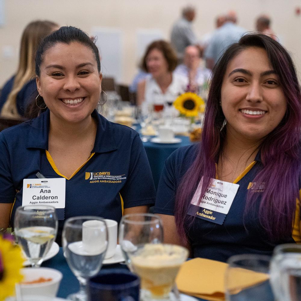 Two students sitting together at a table.