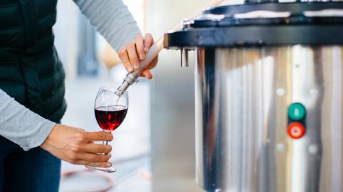Drawing a sample at the Teaching and Research Winery. (UC Office of the President)