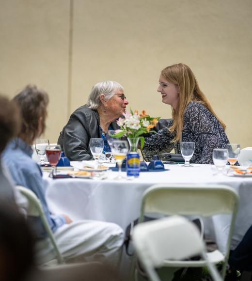 Two people chatting at the Scholarship event.
