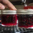 Fresh jelly is prepared in jars.