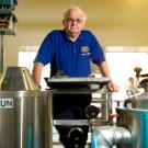 Bamforth standing by brewing equipment