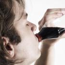 Person consuming beverage.