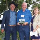 Ken Tate, center, with Rangeland Trust emeritus director Devere Dressler and Rangeland Trust CEO Nita Vail.  Photo by Richard Levine.