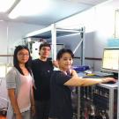 Qi Zhang (right) operates an aerosol mass spectrometer with Ph.D. student Shan Zhou (left) and project scientist Sonya Collier (center) during 2014 field study in Nanjing, China.