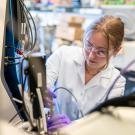 A graduate student working with a bioreactor used in protein separation and meat cultivation. (Jael Mackendorf / UC Davis)