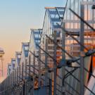 UC Davis CORE greenhouses at sunset with the campus water tower in the background.