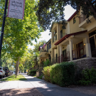 A street with houses with sidewalk.