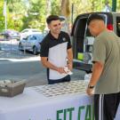Dion Skaria, a food science major, sells his Fit Candy product at the Davis farmer's market. Photo by: Jael Mackendorf, UC Davis.