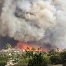 Wildfire smoke from the Woolsey Fire billows over the sky in Malibu, California in November 2018. Aerosols in smoke plumes hundreds of hours old can still affect climate change, a UC Davis study shows. (Getty)