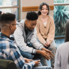 A group of young teenagers talking together.