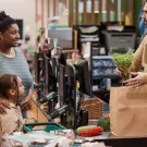 Woman and daughter checking out at grocery store