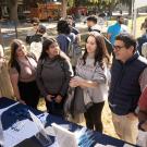 Three undergraduates in "Becoming a Latino Scientist," from the left Kaitlyn Menjivar-Esquivel, Itzel Gonzalez and Peyton Apruzzese, learn about opportunities at the Graduate and Law School Fair on the Quad Oct. 23 for an assignment given by instructor Luis Carvajal-Carmona, (center), a professor of biochemistry and molecular medicine who oversees campuswide Avanza HSI initiatives as associate vice chancellor for academic diversity in Diversity, Equity and Inclusion.