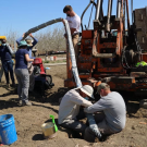 UC Davis researchers insert a device that continuously collects water samples underground, providing real-time data on nitrate contaminant movement. (Isaya Kisekka / UC Davis)