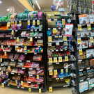 Candy and snack items are displayed for sale in the check out line at a grocery store.
