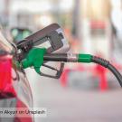 A car getting filled at the gas pump.