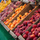 Fruit in boxes for sale at an outdoor market.